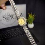 Women watch two tone with yellow color in open straps and front view