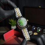 Rolex day-date two tone with green dialer & golden-silver straps in wrist view